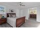 Comfortable bedroom with natural light, gray walls, ceiling fan, and classic sleigh bed frame at 935 Old Loganville Rd, Loganville, GA 30052