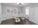 Bright kitchen with white cabinets, stainless steel appliances, a dining table, and natural light at 935 Old Loganville Rd, Loganville, GA 30052