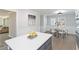 Bright kitchen with white cabinets, stainless steel appliances, island with white countertop, and dining table at 935 Old Loganville Rd, Loganville, GA 30052