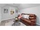 Comfortable living room with a leather sofa, accent pillows, a modern rug, and updated lighting at 935 Old Loganville Rd, Loganville, GA 30052