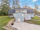 Rear exterior featuring a deck and back door leading to a patio, plus stairs to the yard at 935 Old Loganville Rd, Loganville, GA 30052