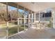A lovely screened porch with a ceiling fan and seating area at 935 Old Loganville Rd, Loganville, GA 30052