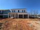 A new home with an attached two-car garage is being built in a residential area with a lawn at , Conyers, GA 30094