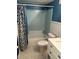Bathroom with blue accents, a shower-tub combo, and a white vanity sink at 1677 Grey Fox Ct, Lawrenceville, GA 30044