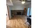 Living room featuring a rock fireplace, wood floors, and natural light at 1677 Grey Fox Ct, Lawrenceville, GA 30044