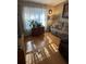 Bright living room featuring a comfortable sofa, hardwood floors, and a decorative display cabinet at 1677 Grey Fox Ct, Lawrenceville, GA 30044