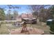 Backyard of property with patio, deck, shed, and swing set for outdoor enjoyment at 181 Pinehurst Ln, Marietta, GA 30068