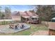 Large backyard with patio, fire pit, wood deck, playset, and storage shed at 181 Pinehurst Ln, Marietta, GA 30068