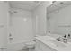 Bright all-white bathroom featuring a tub with shower and a sink with vanity at 181 Pinehurst Ln, Marietta, GA 30068