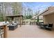 Large wooden deck with multiple seating areas, covered pergola, awning and dining space perfect for outdoor entertaining at 181 Pinehurst Ln, Marietta, GA 30068