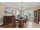 Bright dining room featuring hardwood floors, modern chandelier, and natural light at 181 Pinehurst Ln, Marietta, GA 30068