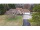 View of the home, highlighting its exterior with a two-car garage and manicured landscaping at 181 Pinehurst Ln, Marietta, GA 30068