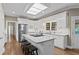 Bright kitchen with white cabinets, granite countertops, stainless steel appliances and island with bar stool seating at 181 Pinehurst Ln, Marietta, GA 30068