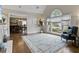 Bright living room with hardwood floors, large windows, a vaulted ceiling, and an open view to the dining room at 181 Pinehurst Ln, Marietta, GA 30068