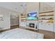 Open-concept living room with fireplace, built-in shelving, hardwood floors, and bright light at 181 Pinehurst Ln, Marietta, GA 30068