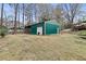 Backyard shed for extra storage with green siding and a single door at 181 Pinehurst Ln, Marietta, GA 30068