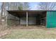 Open shed with green trim on a grassy lot, providing open air storage space at 181 Pinehurst Ln, Marietta, GA 30068