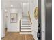 Bright entryway featuring hardwood floors, stairs, and a decorative gold-framed mirror at 1836 Memorial Dr # 303, Atlanta, GA 30317