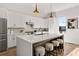 Modern kitchen with white cabinets, stainless steel appliances, and a large center island with seating at 1836 Memorial Dr # 303, Atlanta, GA 30317