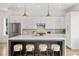 Modern kitchen with white cabinets, stainless steel appliances, and a large center island with seating at 1836 Memorial Dr # 303, Atlanta, GA 30317
