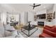 Open-concept living room with a fireplace, media center, modern furniture, and hardwood floors at 1836 Memorial Dr # 303, Atlanta, GA 30317