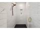 Detailed shot of a tiled shower with bronze fixtures and a black honeycomb floor at 1836 Memorial Dr # 303, Atlanta, GA 30317
