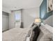 Comfortable bedroom featuring soft bedding, a blue accent wall, and a closet with door open at 3071 Greyton Dr, Buford, GA 30519