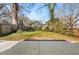 Large backyard with a spacious concrete patio and grass area, surrounded by a wooden fence at 1446 Metropolitan Se Ave, Atlanta, GA 30316