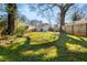 Lush backyard featuring mature trees, grass, and a wooden fence at 1446 Metropolitan Se Ave, Atlanta, GA 30316