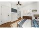 Cozy bedroom featuring hardwood floors, a ceiling fan, and a decorative fireplace at 1446 Metropolitan Se Ave, Atlanta, GA 30316