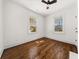 Bedroom with hardwood floors, ceiling fan, and two windows providing natural light at 1446 Metropolitan Se Ave, Atlanta, GA 30316