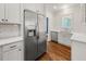 Bright kitchen features stainless steel appliances, white cabinets and wood floors at 1446 Metropolitan Se Ave, Atlanta, GA 30316