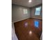 Empty bedroom with two windows providing natural light and unique flooring at 1719 Thoms Nw Dr, Atlanta, GA 30318