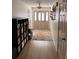 Welcoming foyer with stylish rug and shelving adjacent to hardwood flooring at 180 Collins Way, Locust Grove, GA 30248