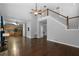 Spacious living room featuring staircase and view into the kitchen at 240 Windy Cir, Mcdonough, GA 30253