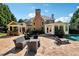 Spacious backyard patio with dining area, lounge furniture, and partial view of swimming pool at 2225 Johnson Ferry Rd., Marietta, GA 30062