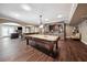 Spacious basement with pool table, bar area, stone accent wall and wood laminate flooring at 2225 Johnson Ferry Rd., Marietta, GA 30062