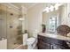 Bathroom with glass enclosed shower, dark wood vanity and neutral color scheme at 2225 Johnson Ferry Rd., Marietta, GA 30062
