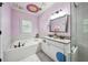 Charming bathroom with double sinks, a soaking tub, a shower, and colorful polka dots at 2225 Johnson Ferry Rd., Marietta, GA 30062