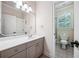 Bathroom featuring a single sink vanity with a large mirror, white cabinets, and tile flooring at 2225 Johnson Ferry Rd., Marietta, GA 30062