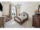 Well-lit bedroom with carpeted floor, large window, ceiling fan, and decorative furniture at 2225 Johnson Ferry Rd., Marietta, GA 30062