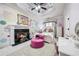 Pink bedroom featuring a fireplace, a white bed, playful wall designs, and a ceiling fan at 2225 Johnson Ferry Rd., Marietta, GA 30062