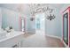 Glamour themed bedroom with chandelier, dressing mirrors and decoratively painted light blue walls at 2225 Johnson Ferry Rd., Marietta, GA 30062