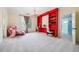 Bright bedroom with a large red bookshelf, built-in desks, carpet, and natural light at 2225 Johnson Ferry Rd., Marietta, GA 30062