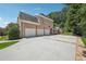 Brick home featuring a three-car garage and manicured lawn at 2225 Johnson Ferry Rd., Marietta, GA 30062