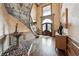 Spacious foyer with stained glass windows, a curved staircase, hardwood floors, and fountain at 2225 Johnson Ferry Rd., Marietta, GA 30062