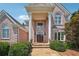 Elegant front entrance with stately pillars, double doors, and manicured landscaping at 2225 Johnson Ferry Rd., Marietta, GA 30062