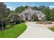 Well-manicured lawn, fountain, and circular driveway leading up to a stately brick home at 2225 Johnson Ferry Rd., Marietta, GA 30062