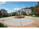 Stunning two-story brick home features a circular driveway with a fountain and lush landscaping at 2225 Johnson Ferry Rd., Marietta, GA 30062