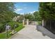 Private gated entrance features meticulously manicured landscaping leading to the home at 2225 Johnson Ferry Rd., Marietta, GA 30062